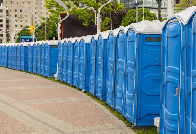 a line of portable restrooms at a sporting event, providing athletes and spectators with clean and accessible facilities in Dibble